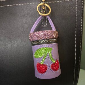 Cylinder Bag Charms with Cherry Rhinestones.  Available in Pink or Lavender.